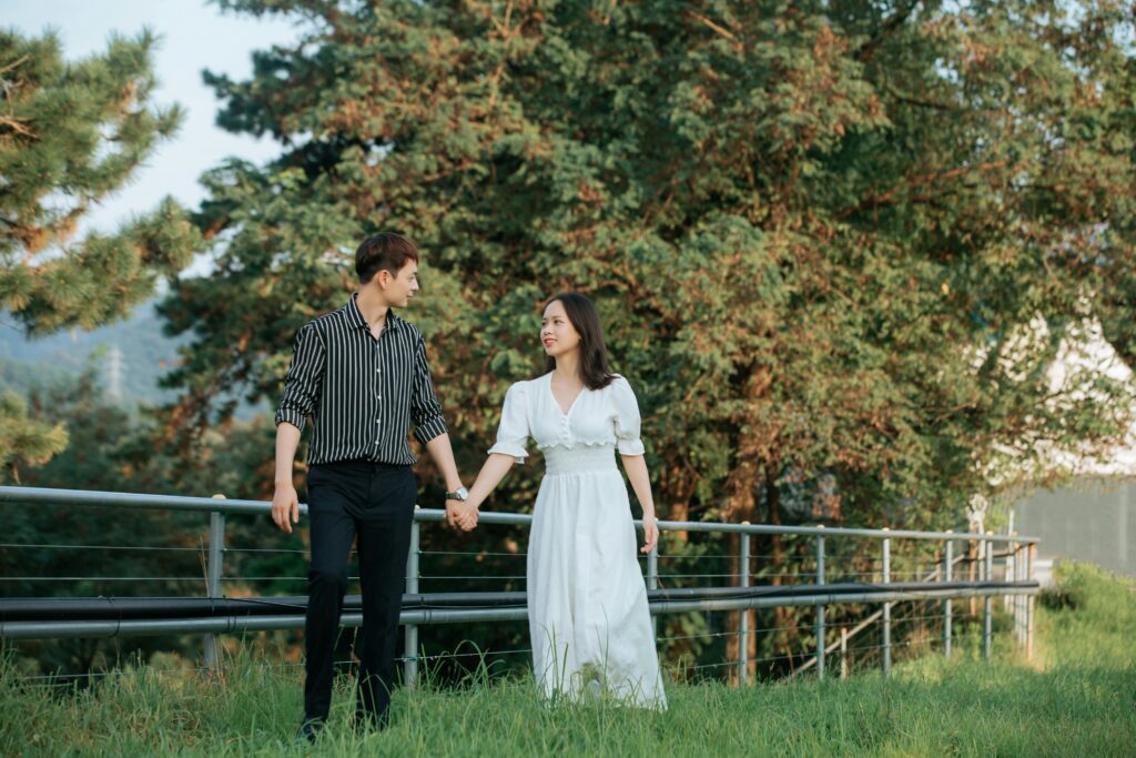Securely attached couple standing in field