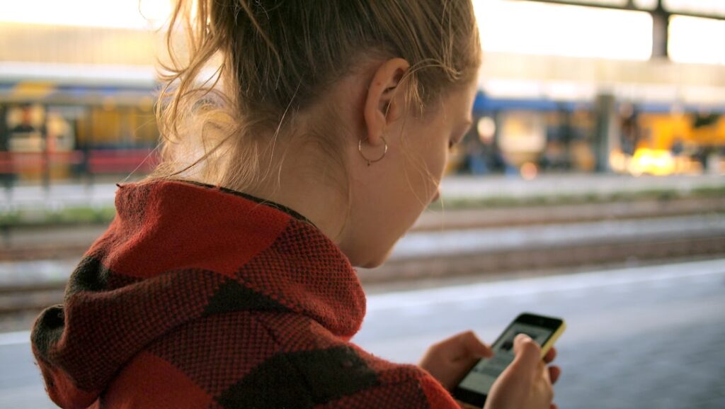 teenage girl looking at cell phone