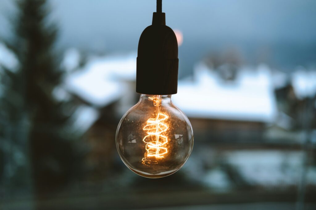Edison light bulb with blurry mountain background