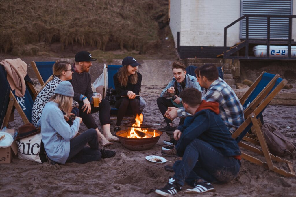 Diverse group of friends gathered around a campfire, sharing stories and creating bonds that define chosen family