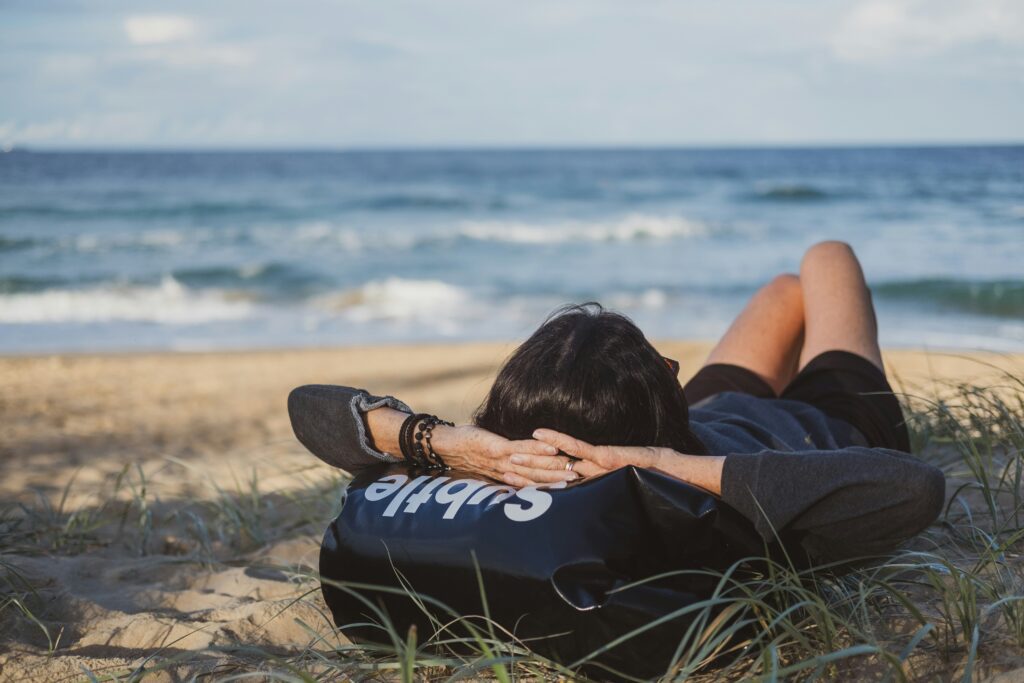 Person relaxing on a beach, symbolizing rest and stress relief—Christian counseling in Chicago offers faith-based support for coping with stress and burnout.