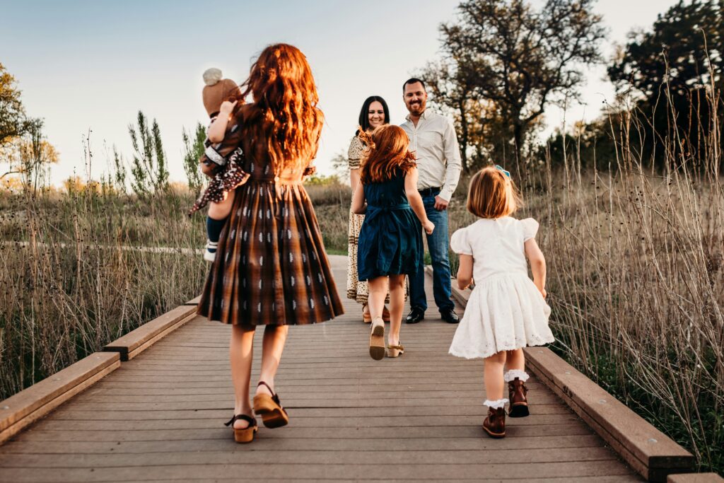 A joyful Christian family walking together on a nature path, symbolizing love, connection, and the strength of family bonds.