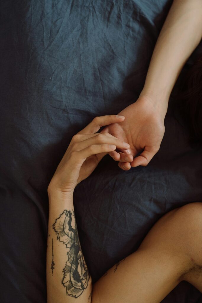 A close-up of hands touching, symbolizing trust, connection, and mindful Sensate Focus exercises for couples.