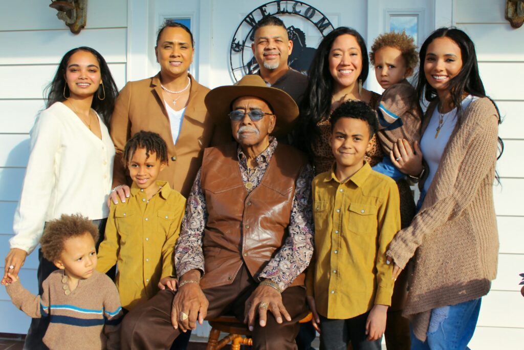 Multigenerational family portrait showing diverse chosen and biological family members united together
