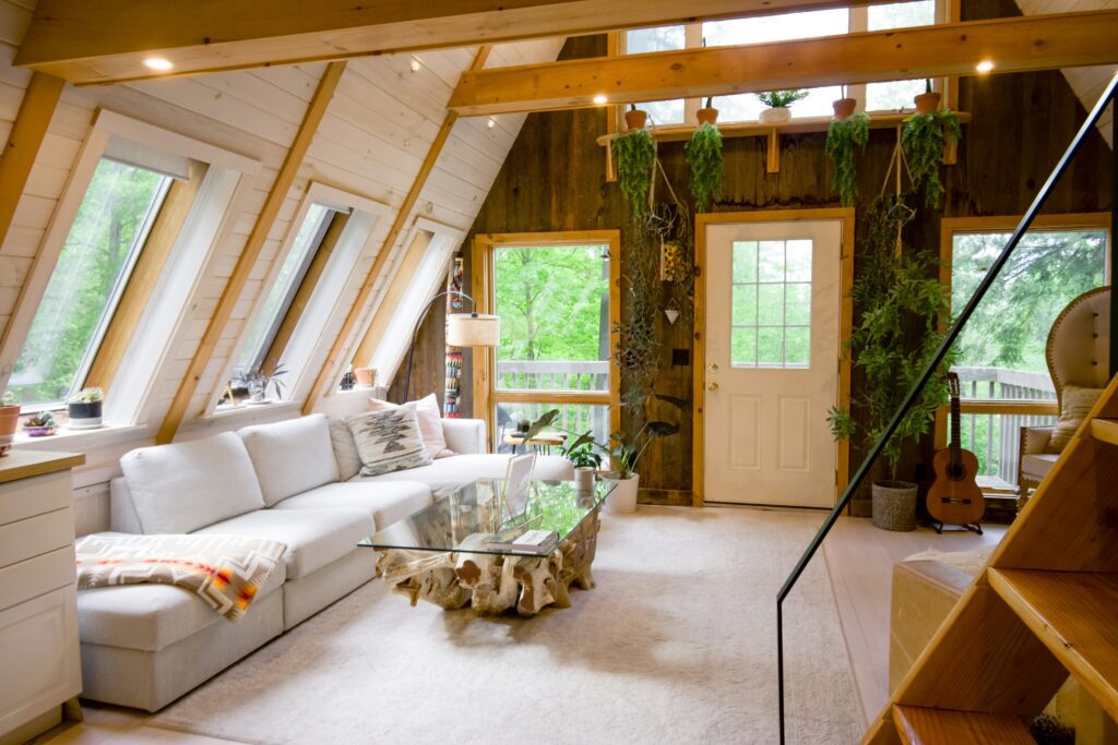 Bright, peaceful cabin living room with natural wood and plants, ideal for creating a serene environment for solo EMDR practice.