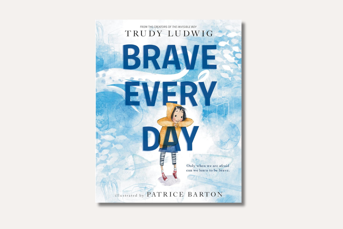 Illustration of a thoughtful girl in a yellow hoodie leaning on large text that reads “Brave Every Day” by Trudy Ludwig.