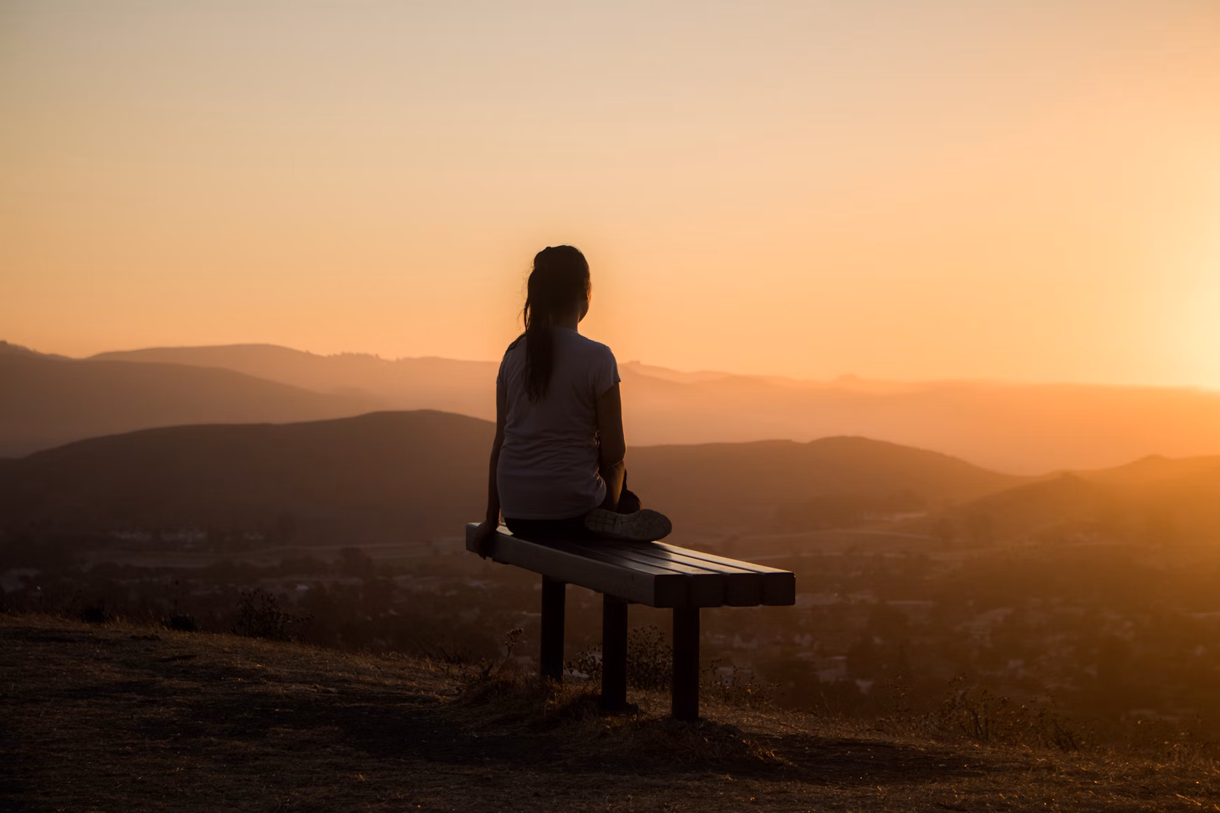 Person using essential oils outdoors as part of OCD recovery journey, integrating aromatherapy with mindfulness practice