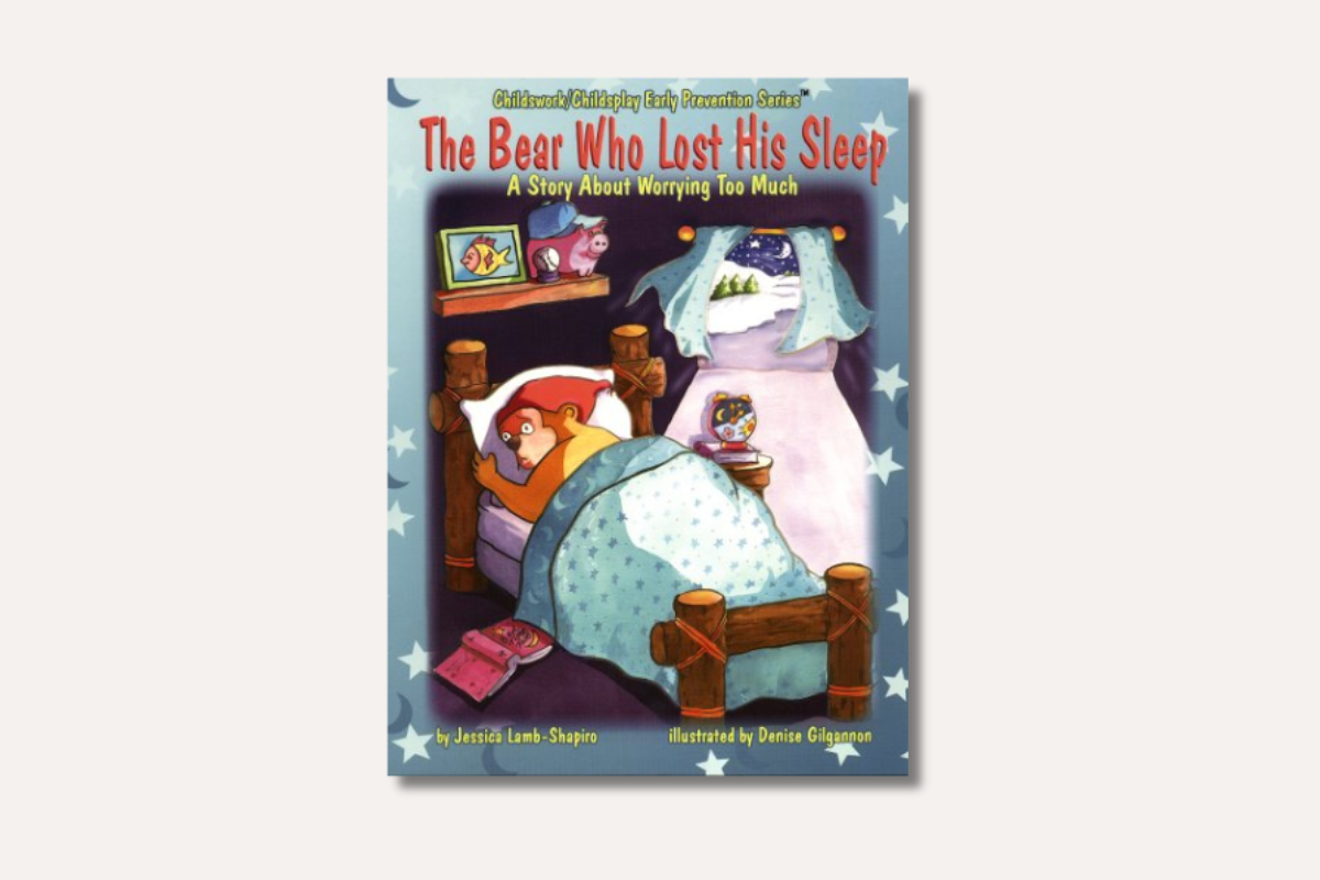 Book cover of *The Bear Who Lost His Sleep*, showing a worried bear lying awake in bed under starry blankets in a cozy room.