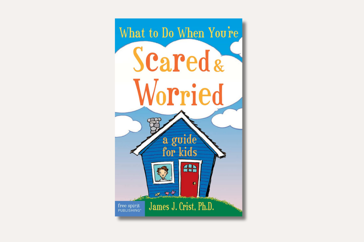 Book cover of *What to Do When You're Scared & Worried*, showing a child in a window of a blue house under a cloudy sky.