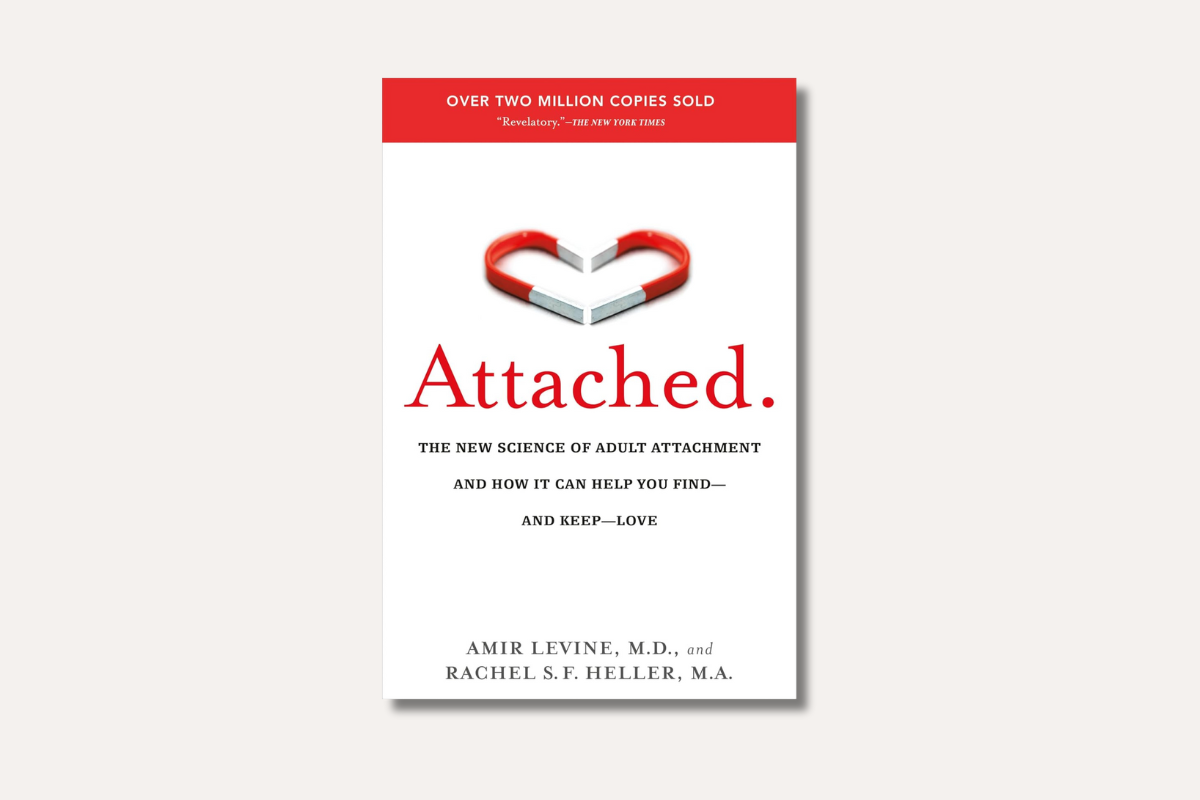 Book cover of ‘Attached: The New Science of Adult Attachment’ by Amir Levine and Rachel Heller — features a heart-shaped magnet symbolizing love and connection