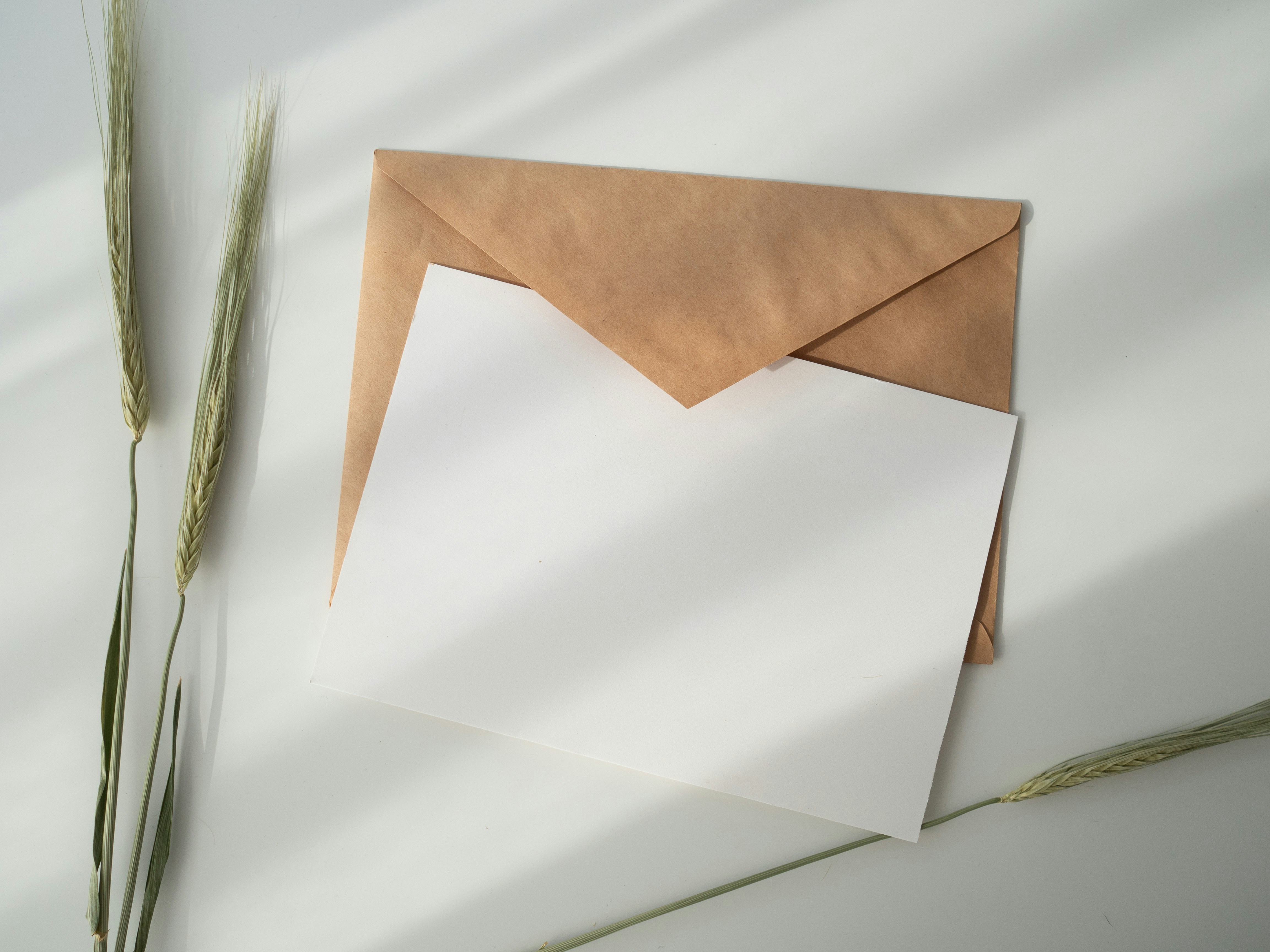 Blank card and brown envelope on white table — a thoughtful handwritten letter for a grieving mother
