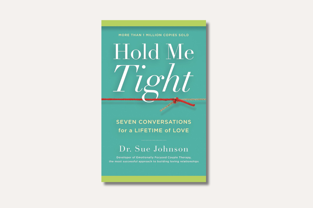 Book cover of ‘Hold Me Tight’ by Dr. Sue Johnson — turquoise and green cover with a red string symbolizing emotional bonds and conversations that build lasting love