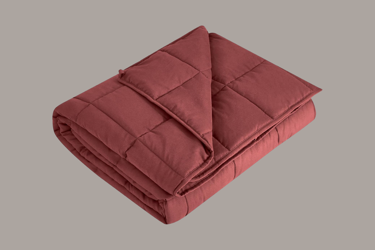 Soft red weighted blanket folded neatly — a cozy comfort gift for a grieving mother